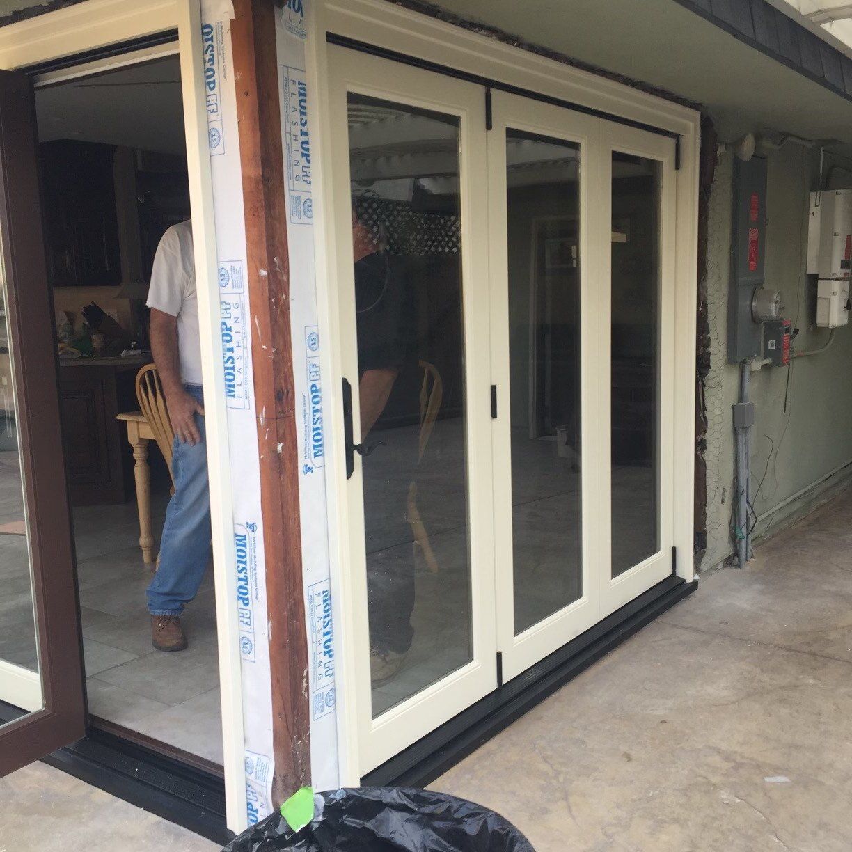 A man standing in front of a sliding glass door that says ' sliding glass ' on it