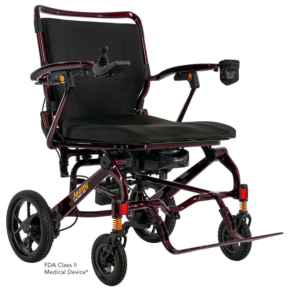 Black folding electric wheelchair with maroon frame, padded seat, armrests, and front caster wheels on white background