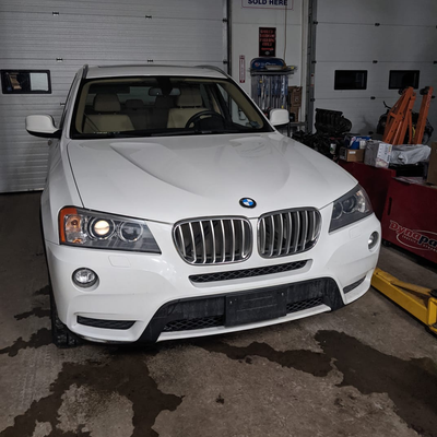 Rb Garage - A white bmw is parked in front of a garage door