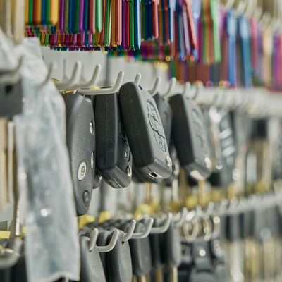 Rb Garage - A bunch of car keys hanging on hooks in a store.