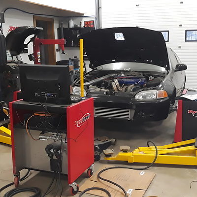 Rb Garage - A car is being worked on in a garage with the hood open