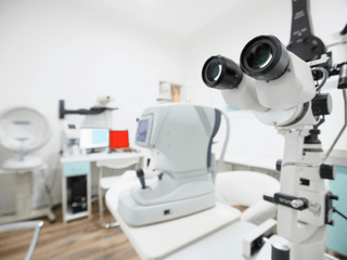 A microscope is sitting on a table in an ophthalmology office.