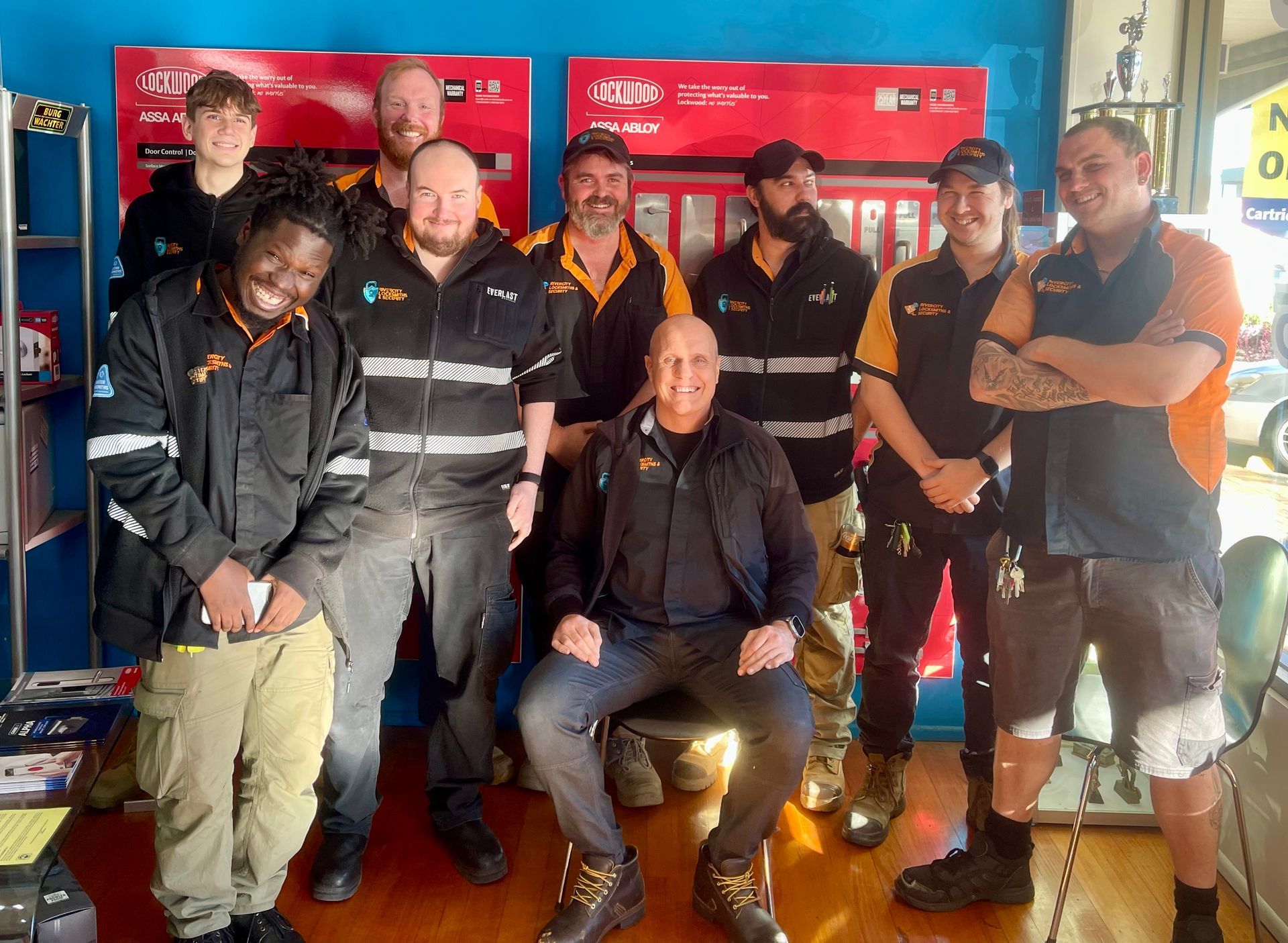 Rivercity Locksmiths' crew posing for a picture in a room.