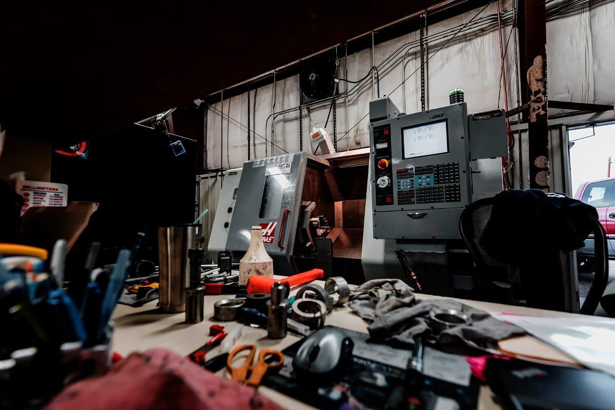 A man is working on a machine in a garage.