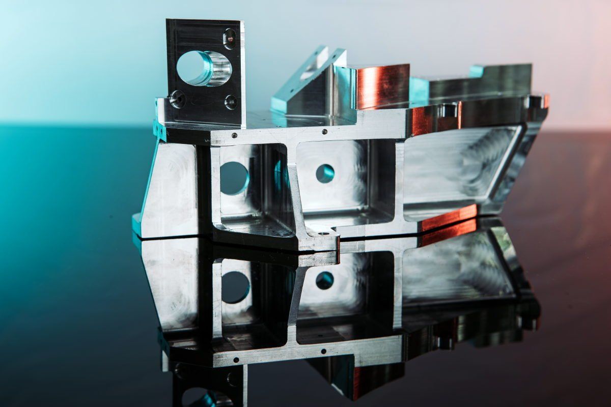 A metal object is sitting on top of a glass table.