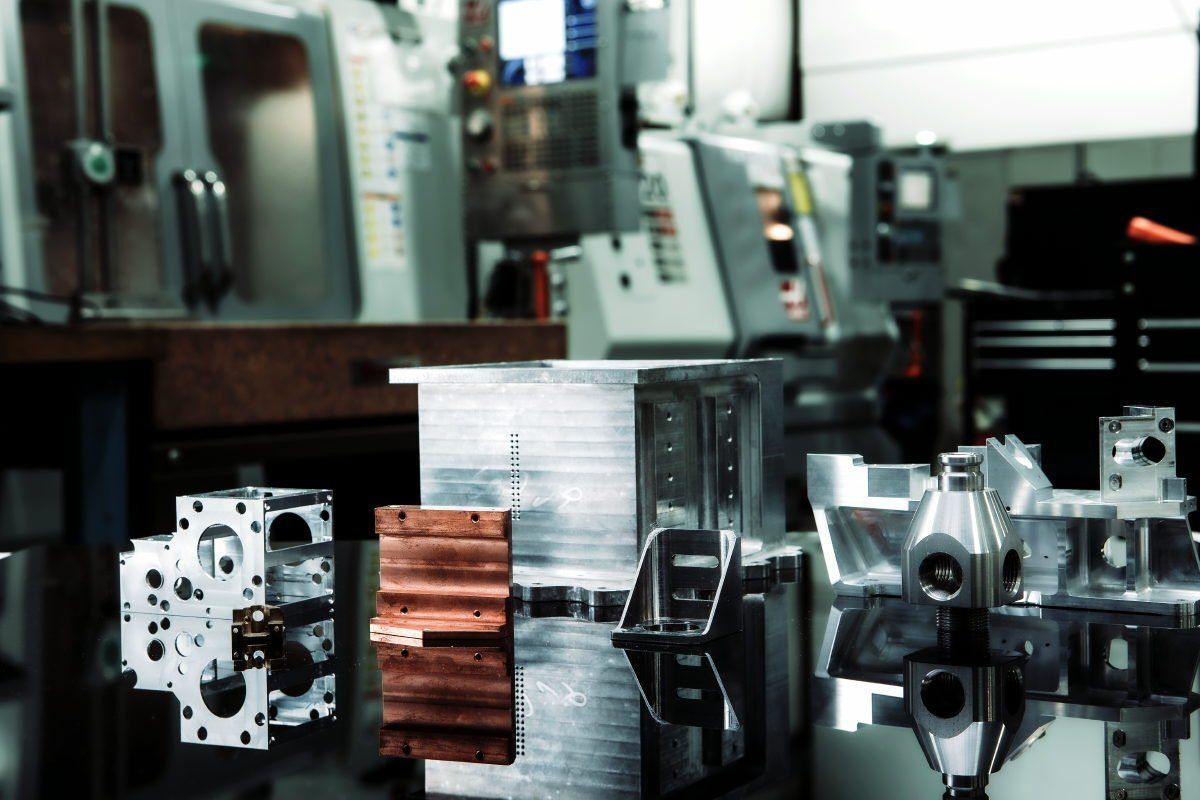 A bunch of metal pieces are sitting on a table in a factory