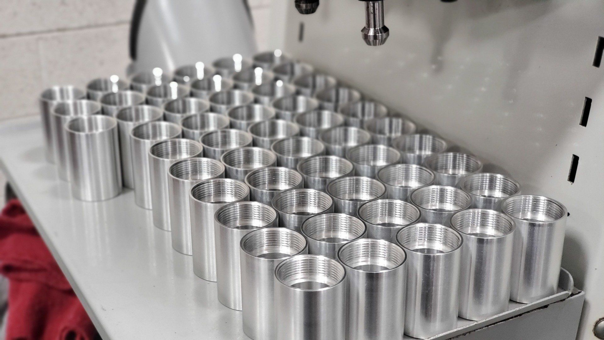 A bunch of metal cylinders are stacked on top of each other on a table.
