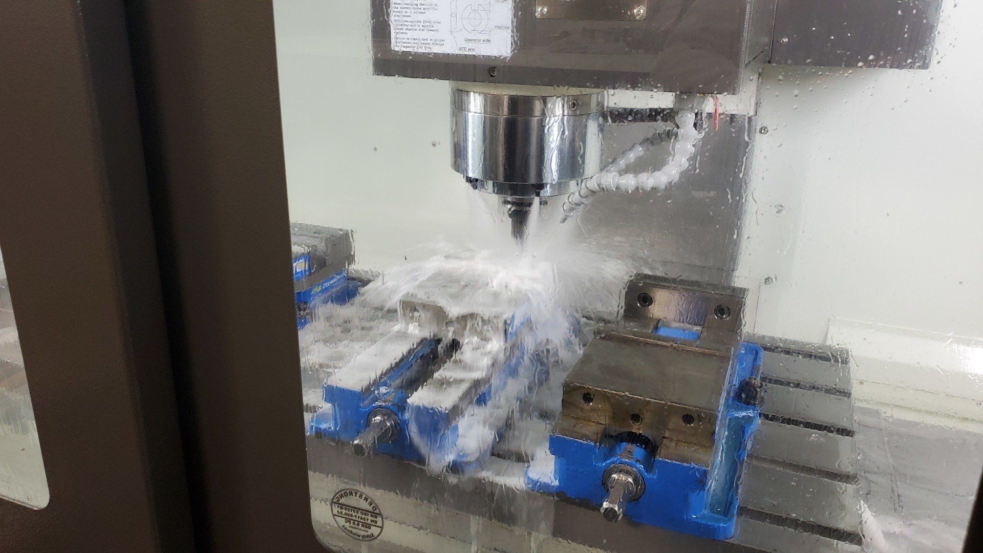 A machine is cutting a piece of metal in a factory.