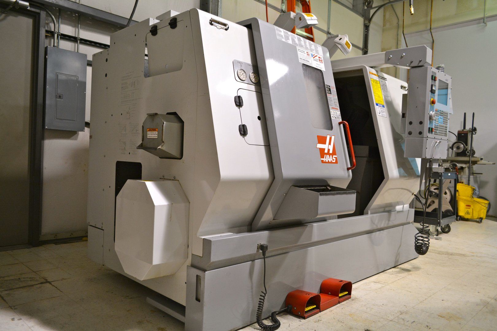 A large machine is sitting in a room in a factory.