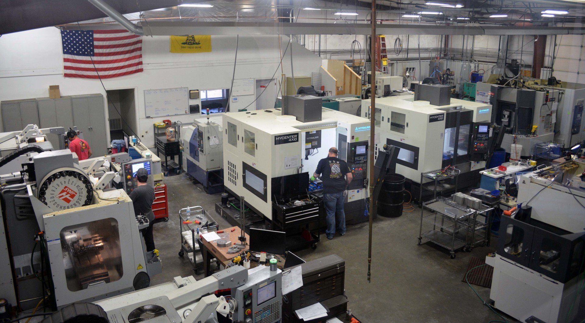 An aerial view of a factory filled with lots of machines and people.