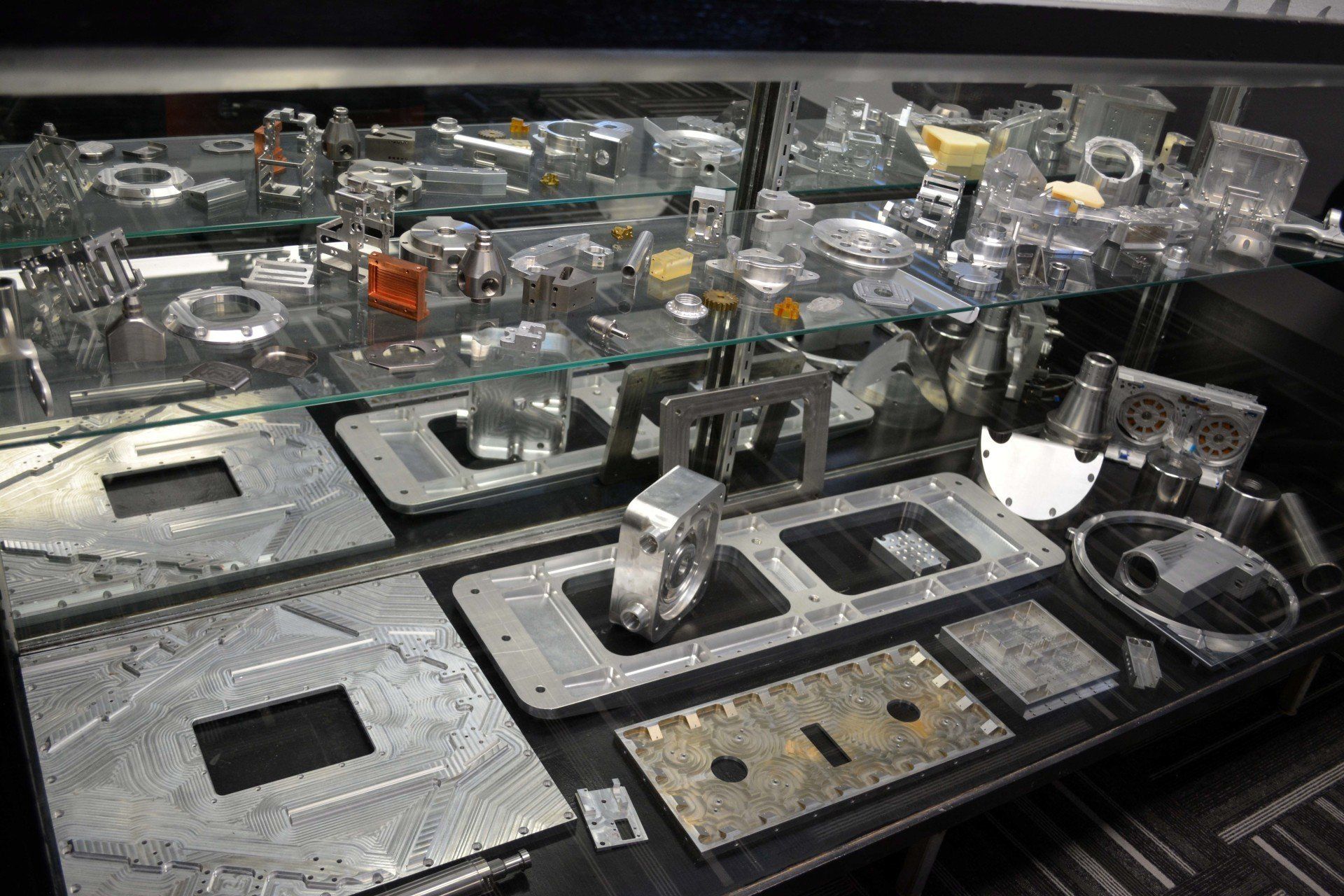 A display case filled with a variety of metal parts