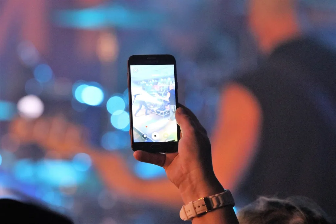 A person is taking a picture with a cell phone