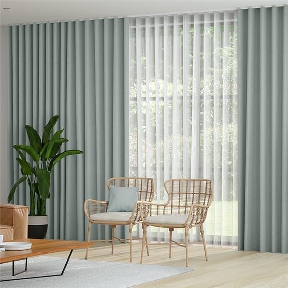 A living room with two chairs , a coffee table , and a plant — Curtain Force NQ in Garbutt, QLD