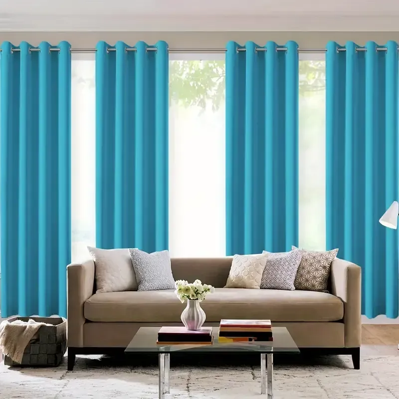 A Living Room With a Couch and Blue Curtains — Curtain Force NQ in Garbutt, QLD