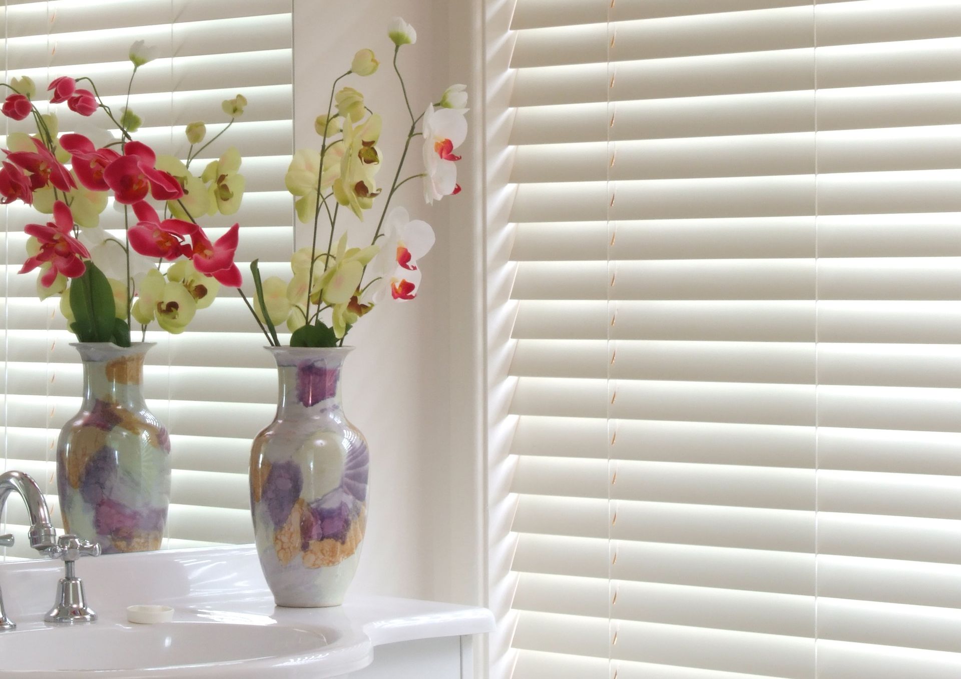 A Bathroom With Two Vases of Flowers — Curtain Force NQ in Garbutt, QLD