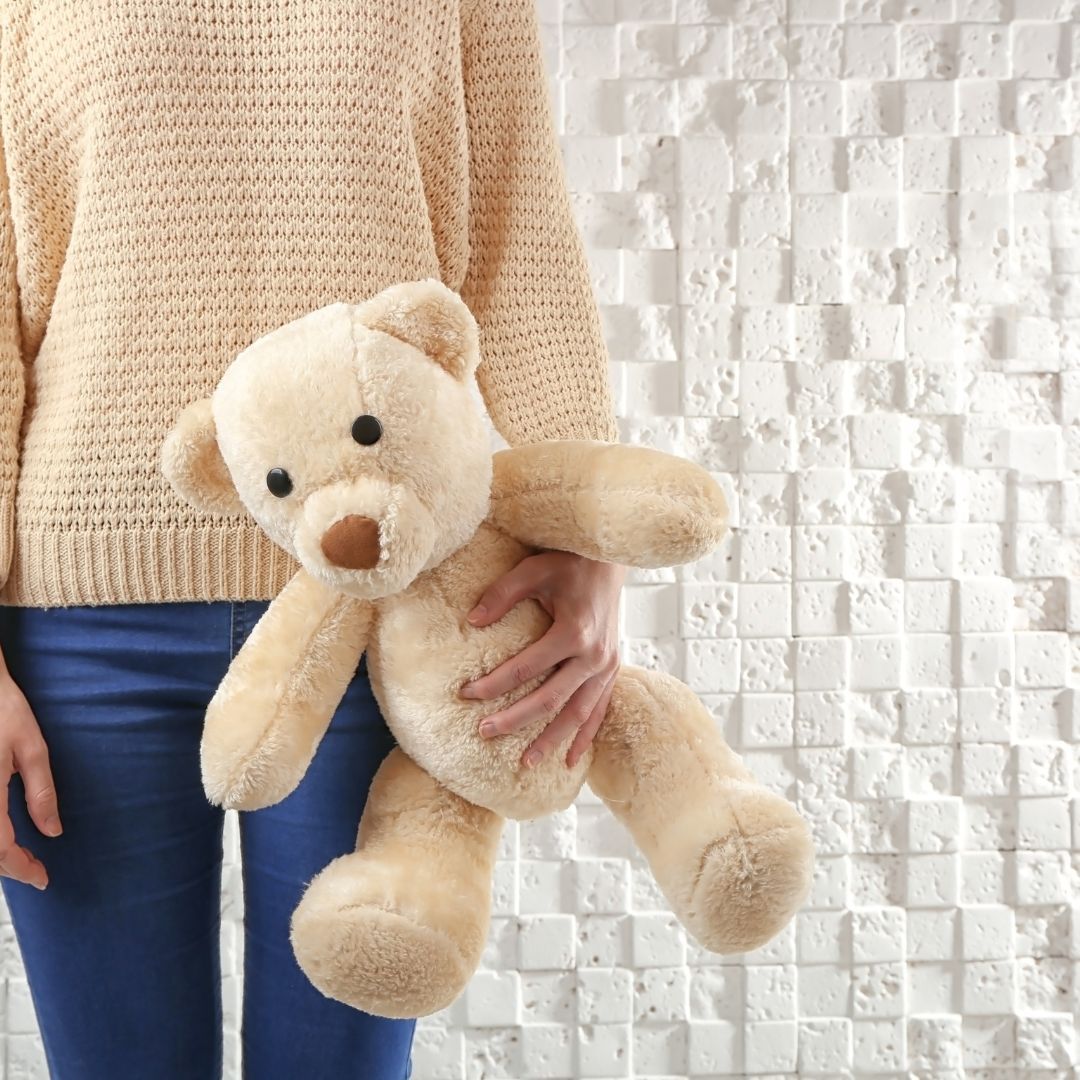 child holding teddy bear