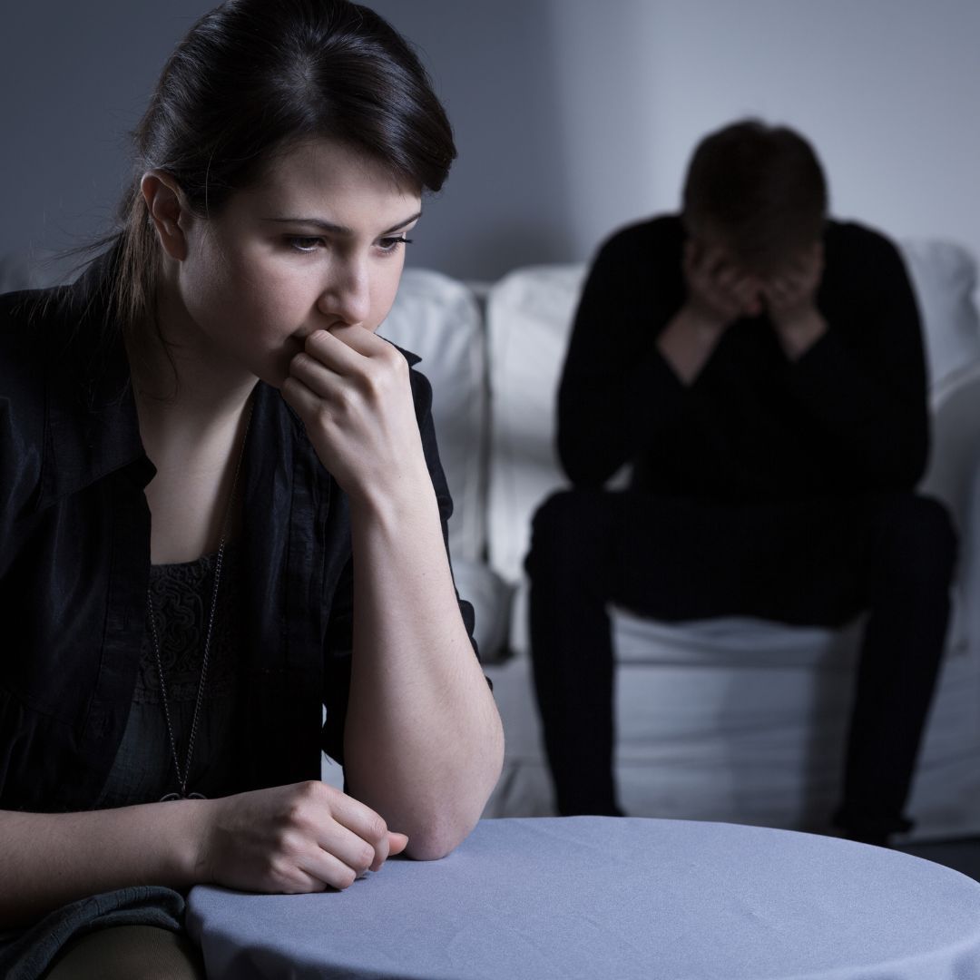 sad couple in living room