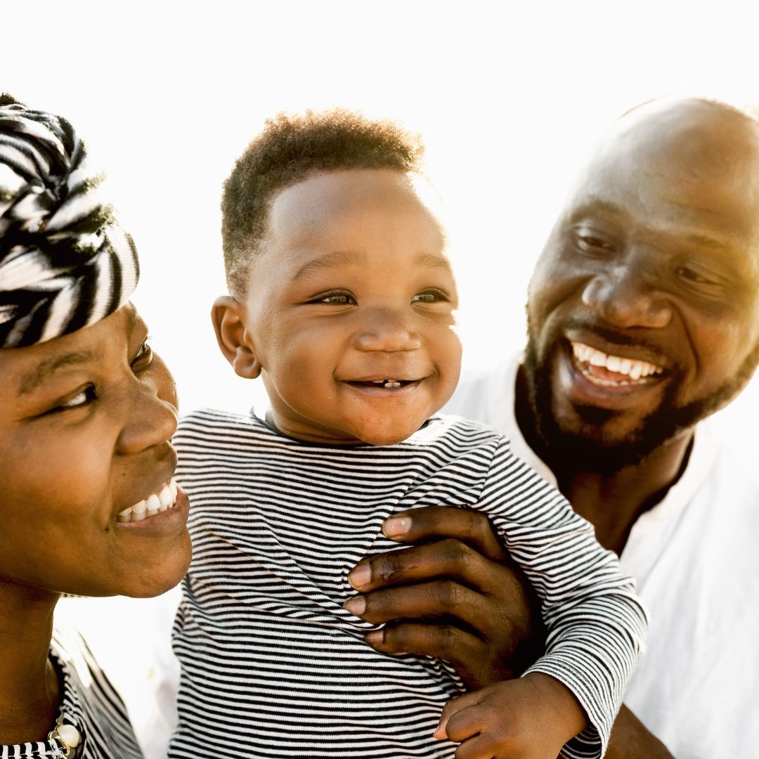 parents holding child