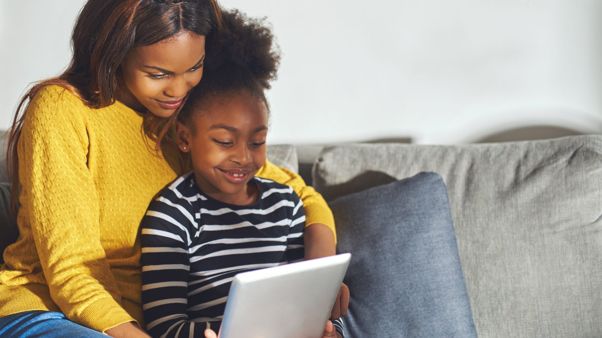 child sitting with mom on couch