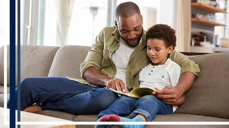 man reading child a book