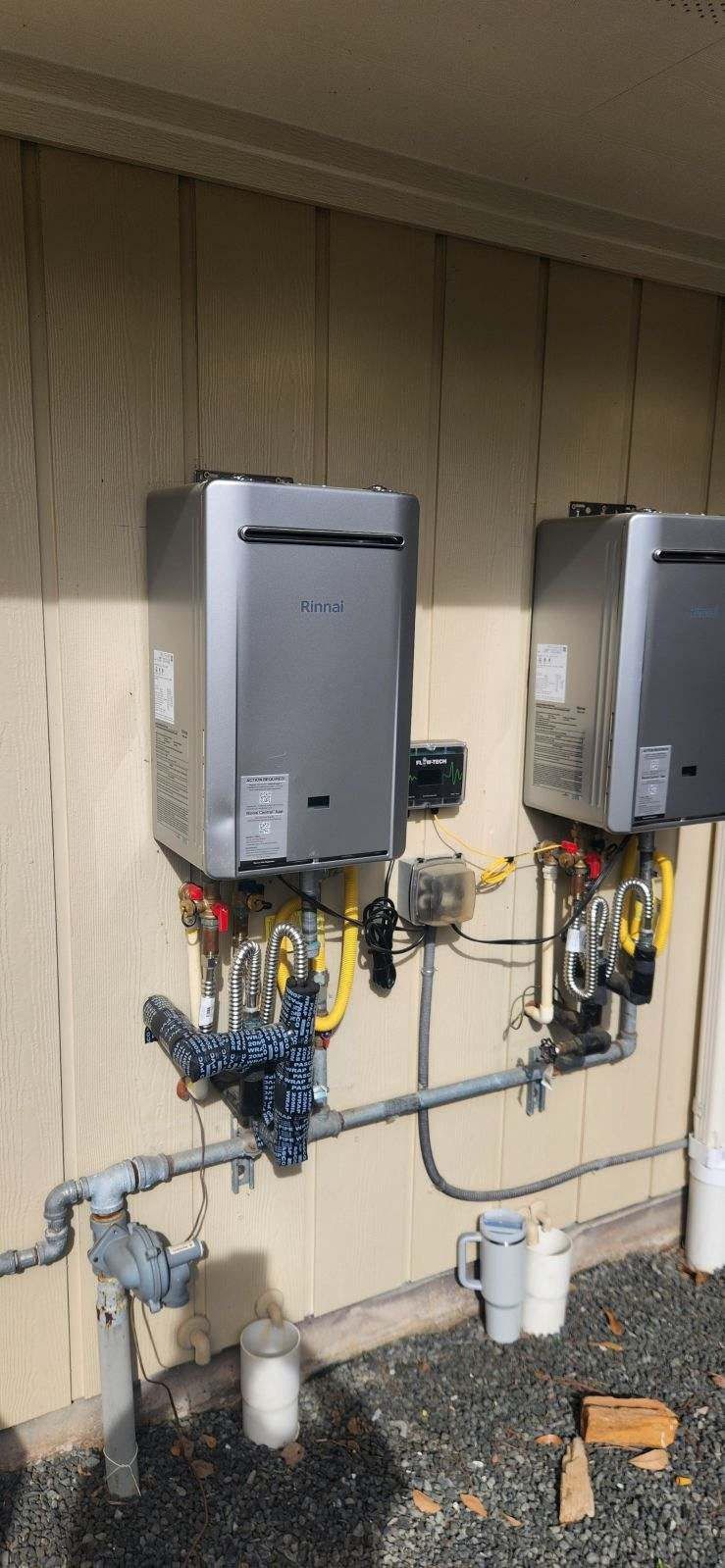 Water softener and tankless water heater in a garage.