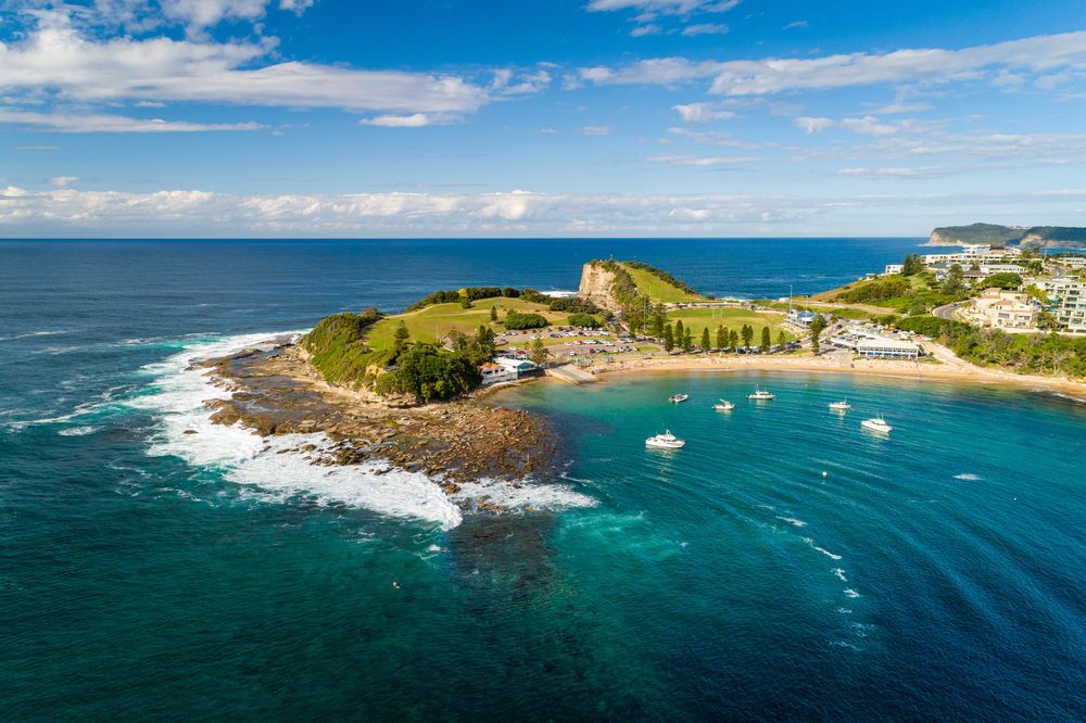 Aerial View of a Rocky Coastal Cove With Turquoise Water — Gutterworx in Terrigal, NSW