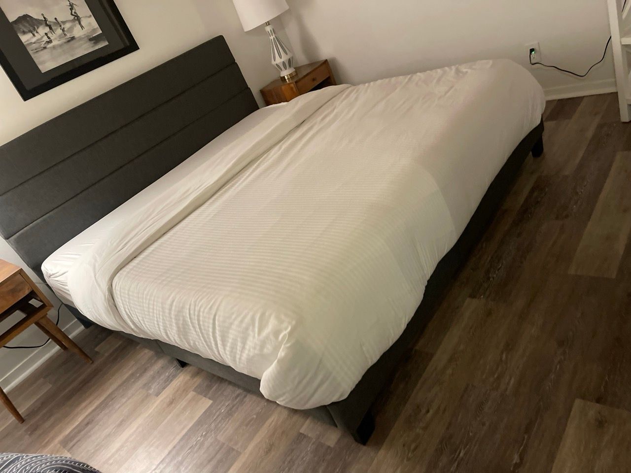 A hotel room with a bed and a lamp