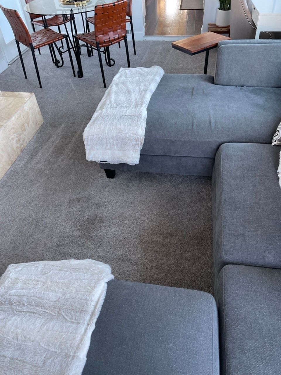 A living room with a sectional couch and chairs