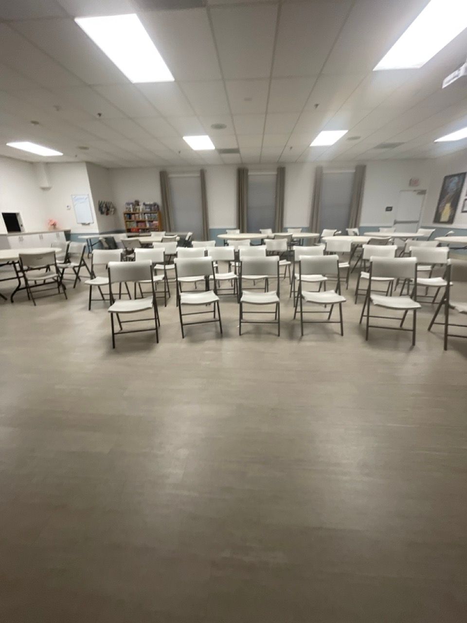 A large room with tables and chairs in it