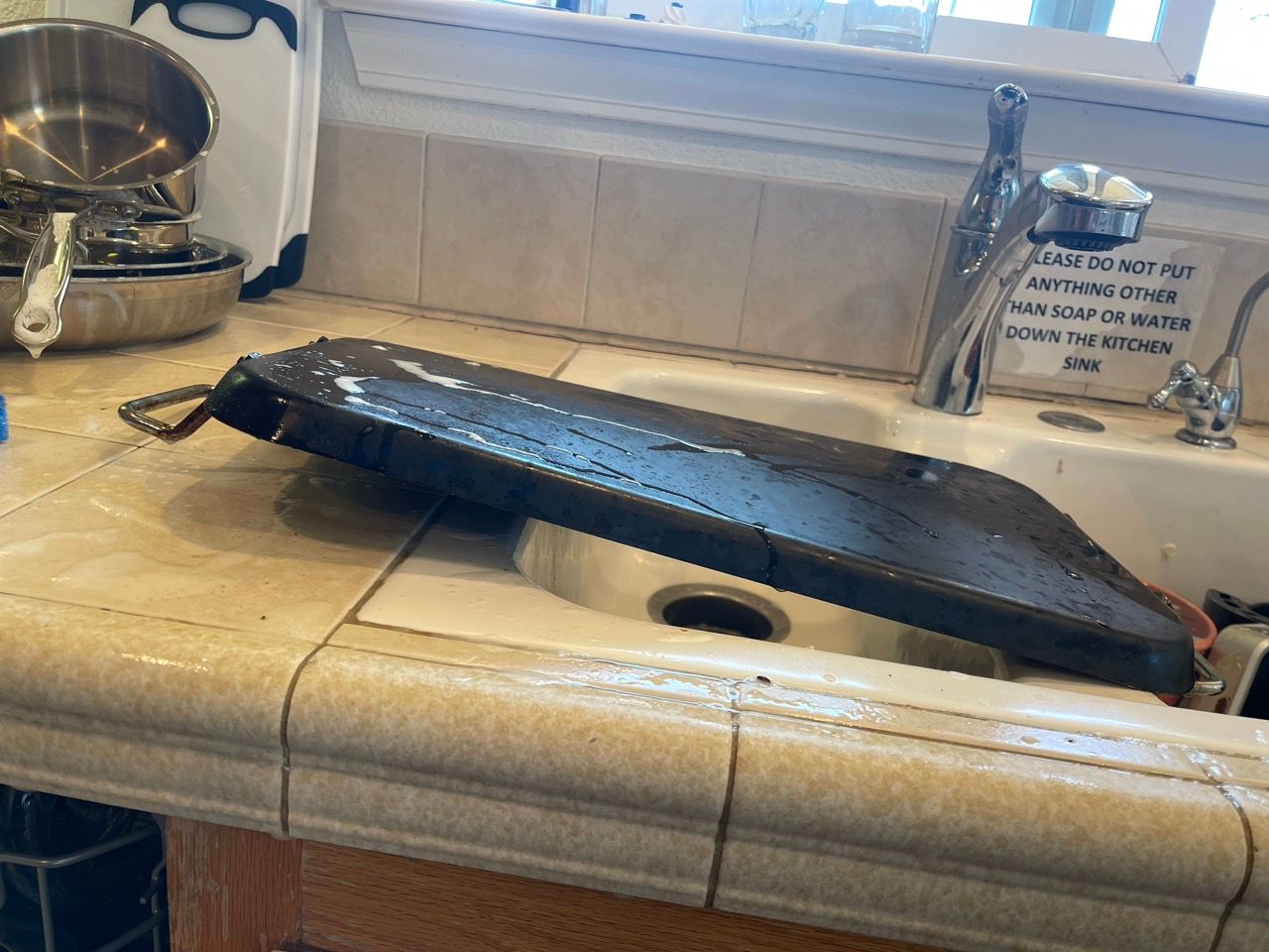 A cutting board is sitting on a counter next to a sink