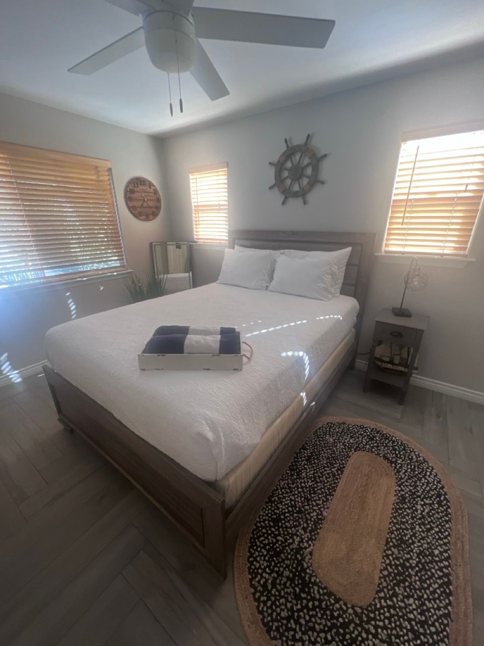 A bedroom with a large bed and a ceiling fan