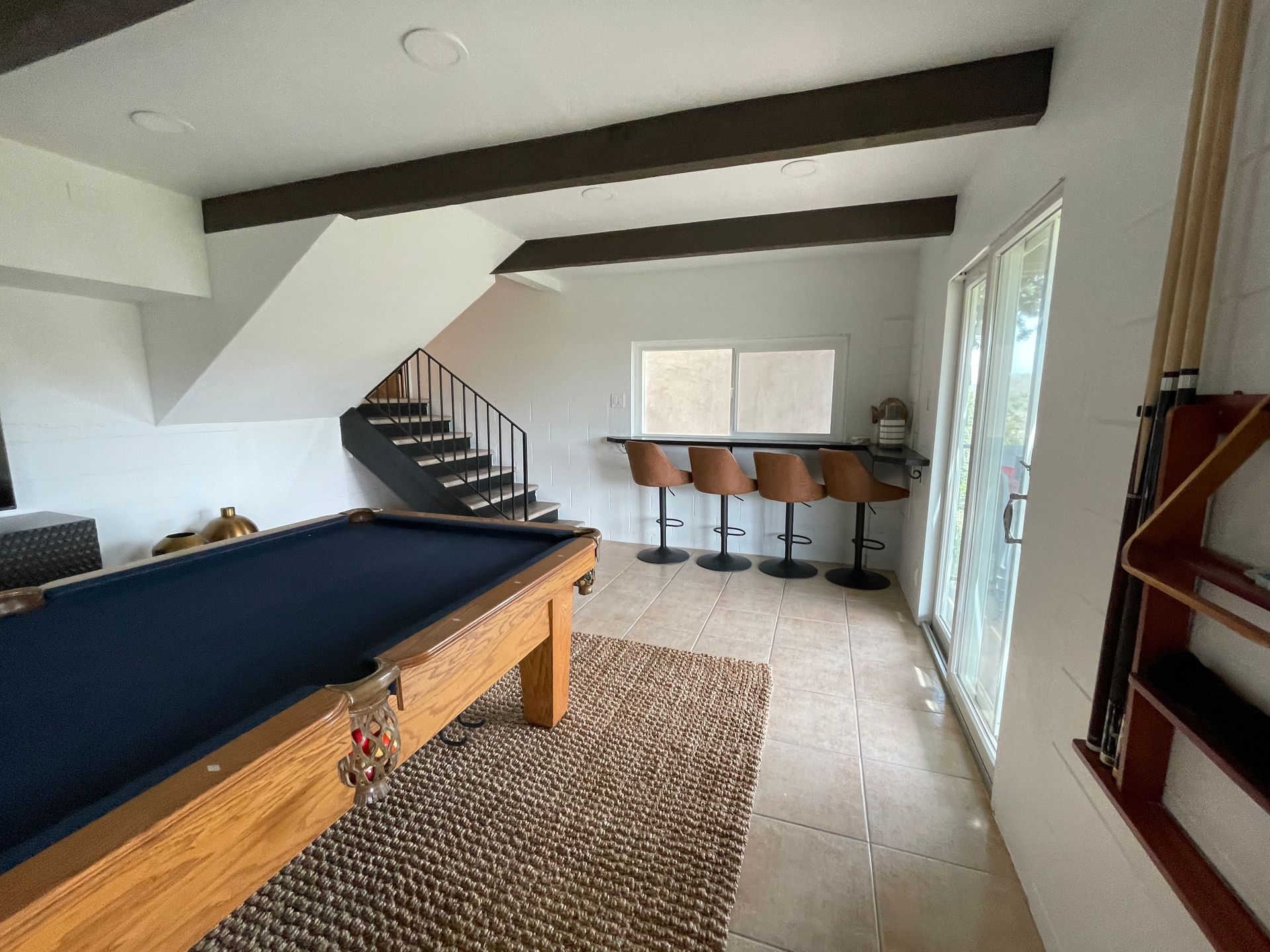 There is a pool table in the middle of the room.