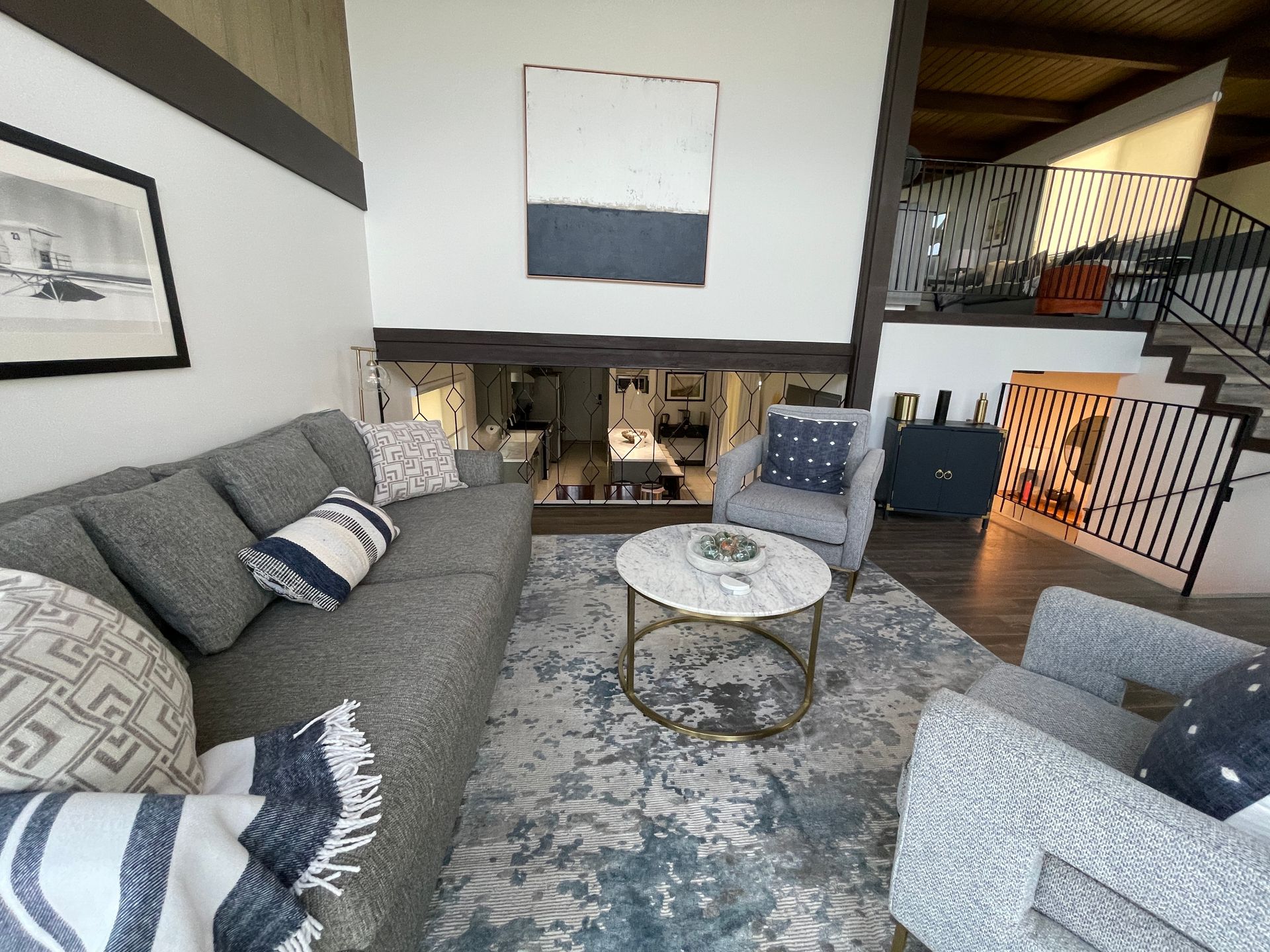 A living room with a couch , chairs and a coffee table