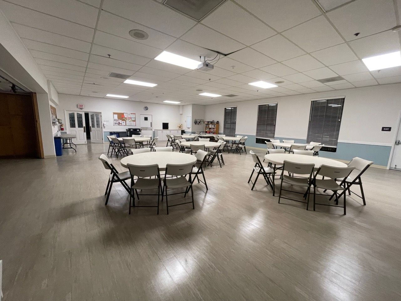 A large room with tables and chairs in it