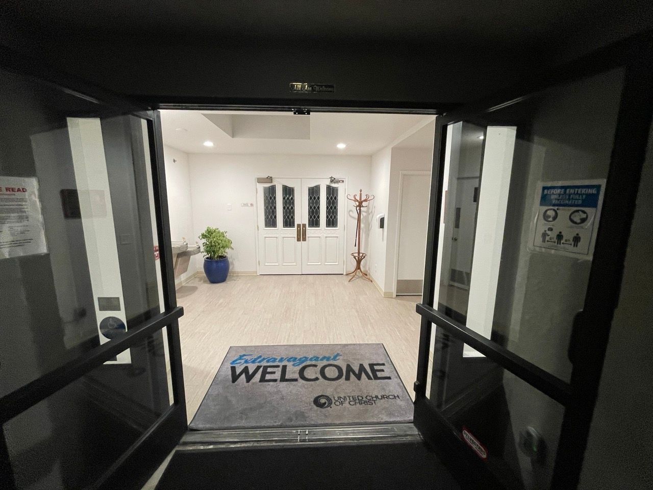An entrance to a building with a welcome mat on the floor