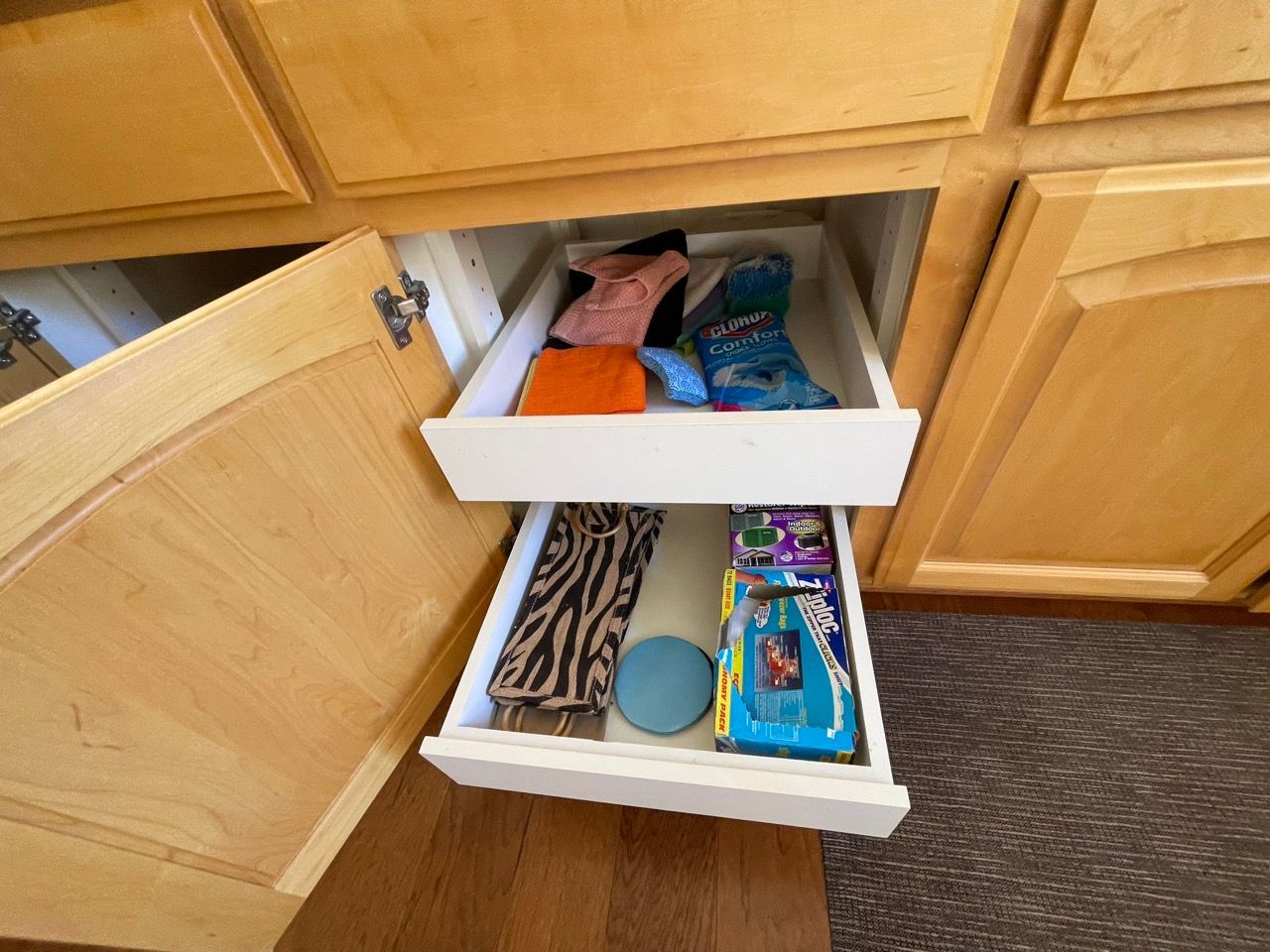 A drawer in a cabinet with a few items in it
