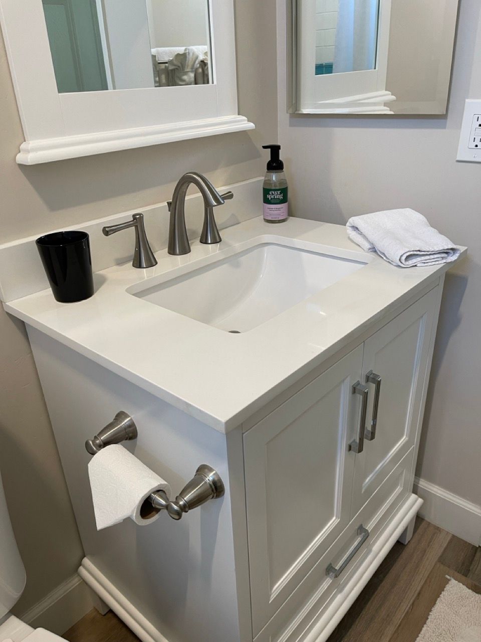 A bathroom vanity with a sink and a mirror