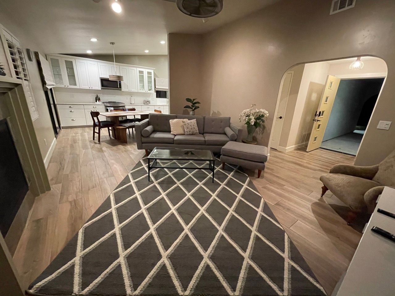 A living room with a rug and a couch