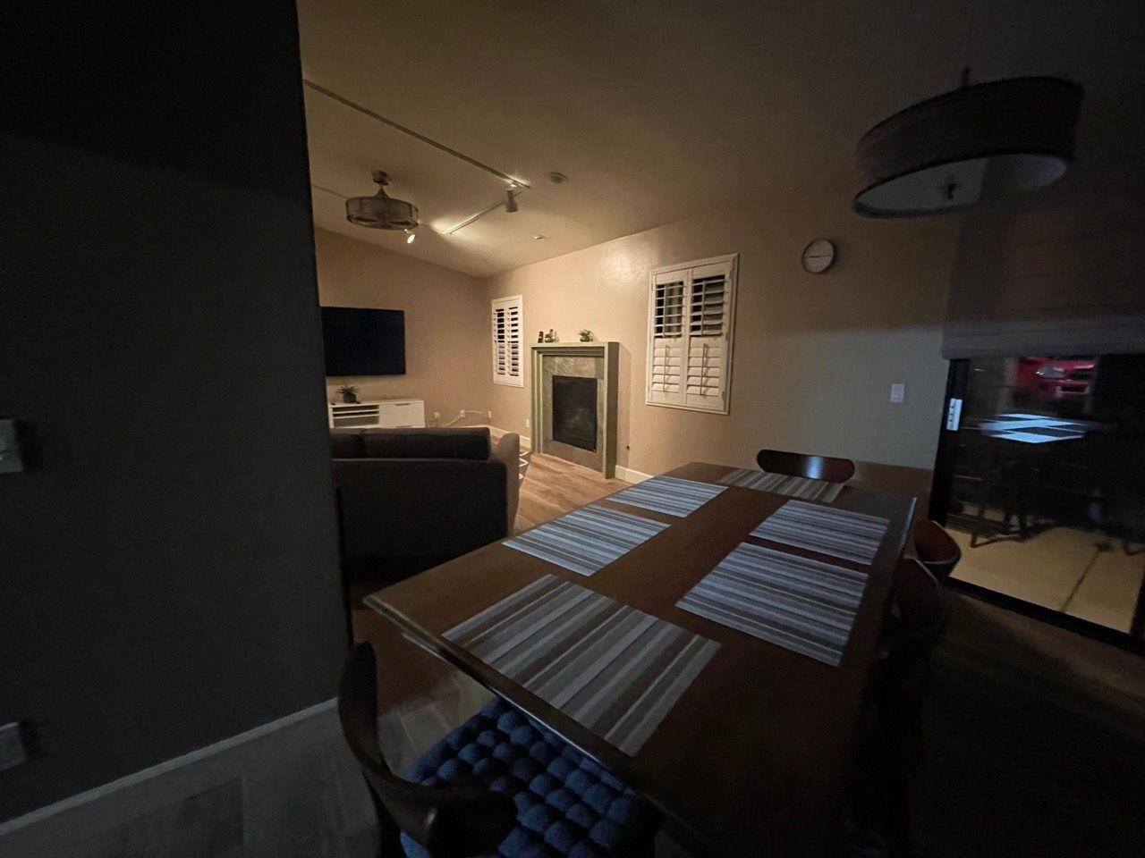 A living room with a table and chairs and a fireplace