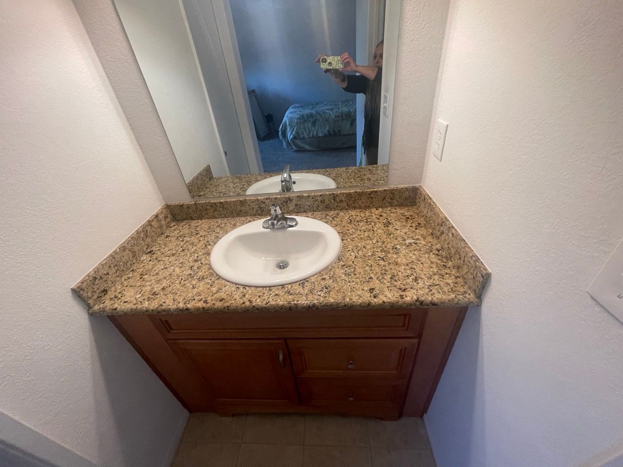 A bathroom with a sink and a mirror.