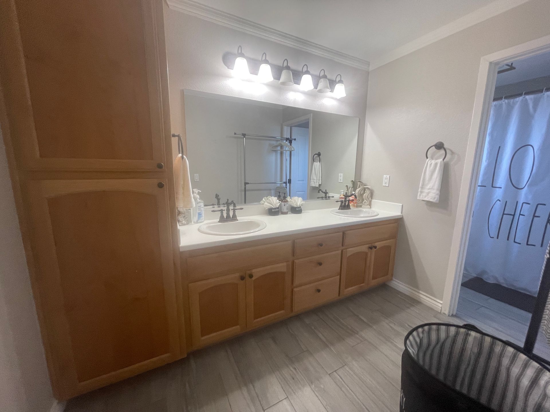 A bathroom with two sinks and a large mirror.