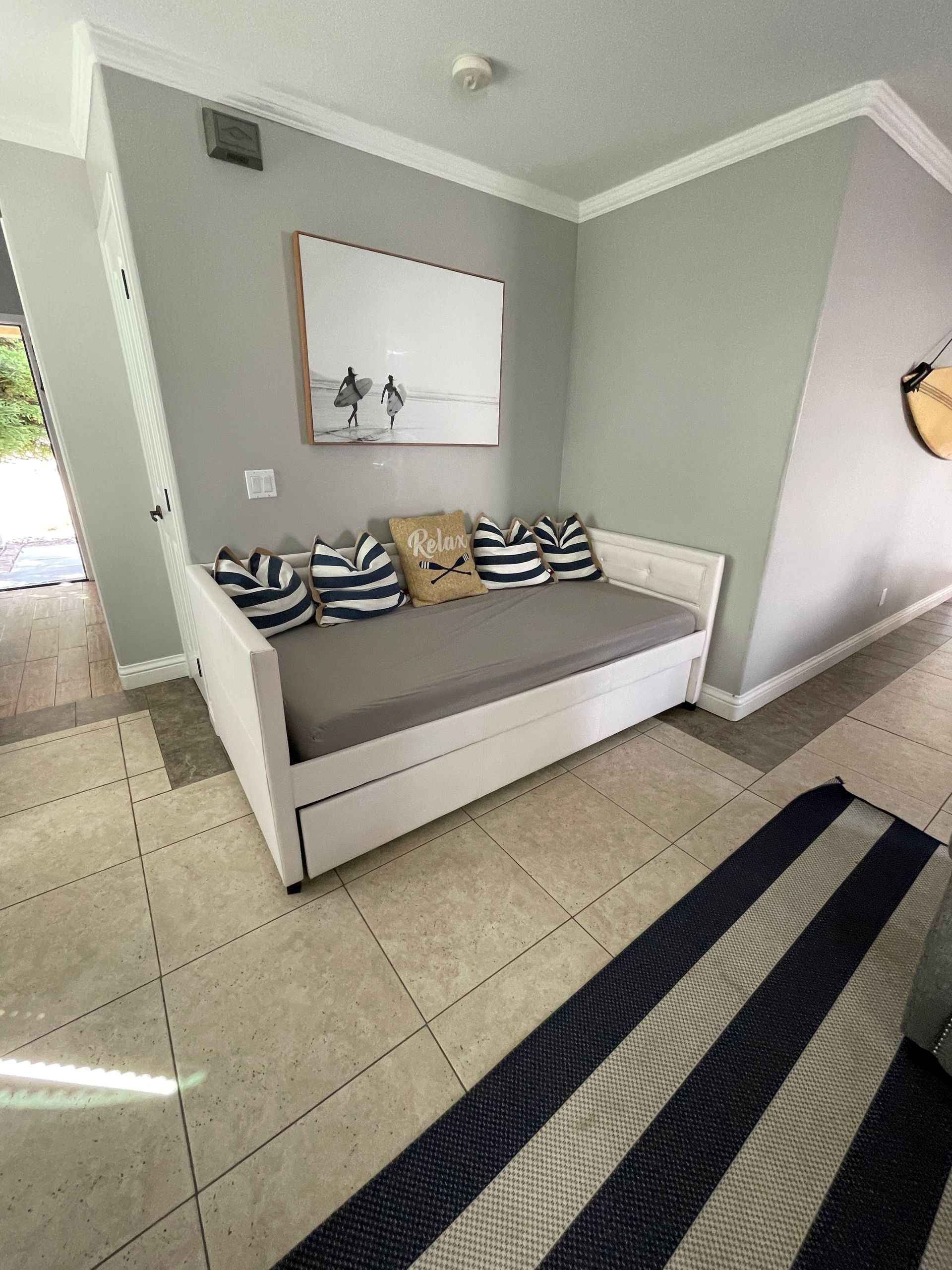 A living room with a couch and a rug