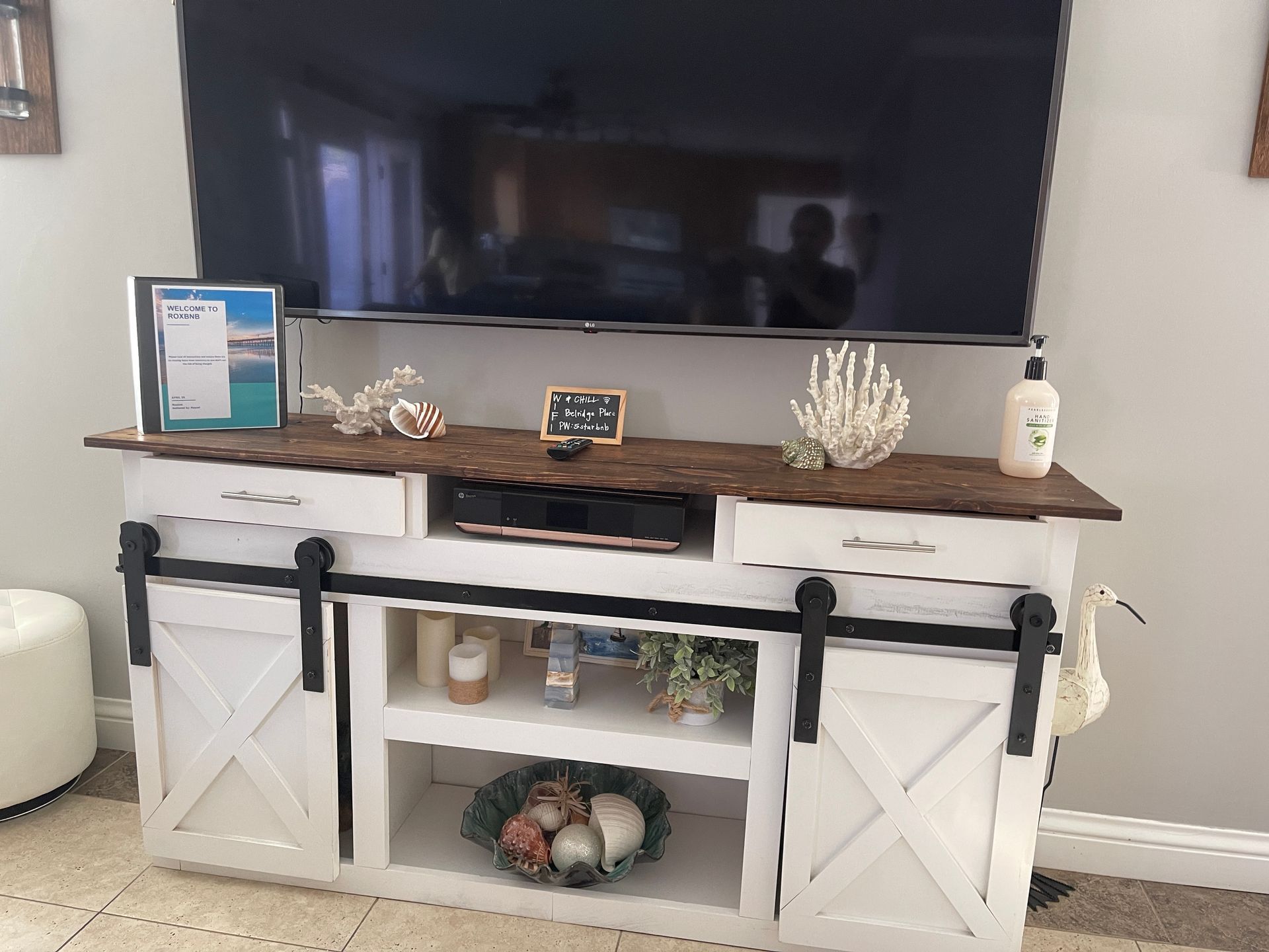 A living room with a white entertainment center and a flat screen tv.
