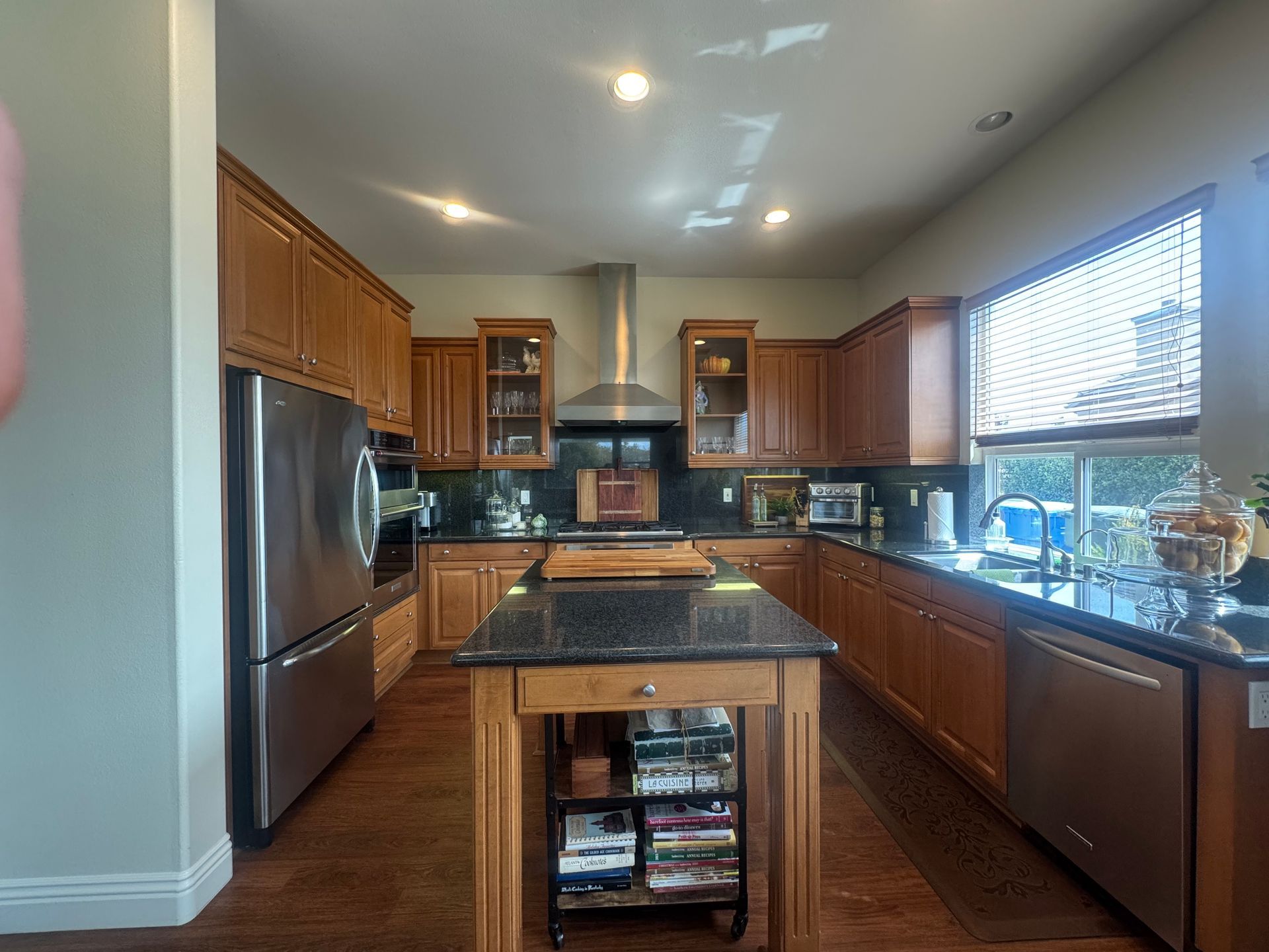 Kitchen with wooden cabinets, stainless steel appliances, and a kitchen island.