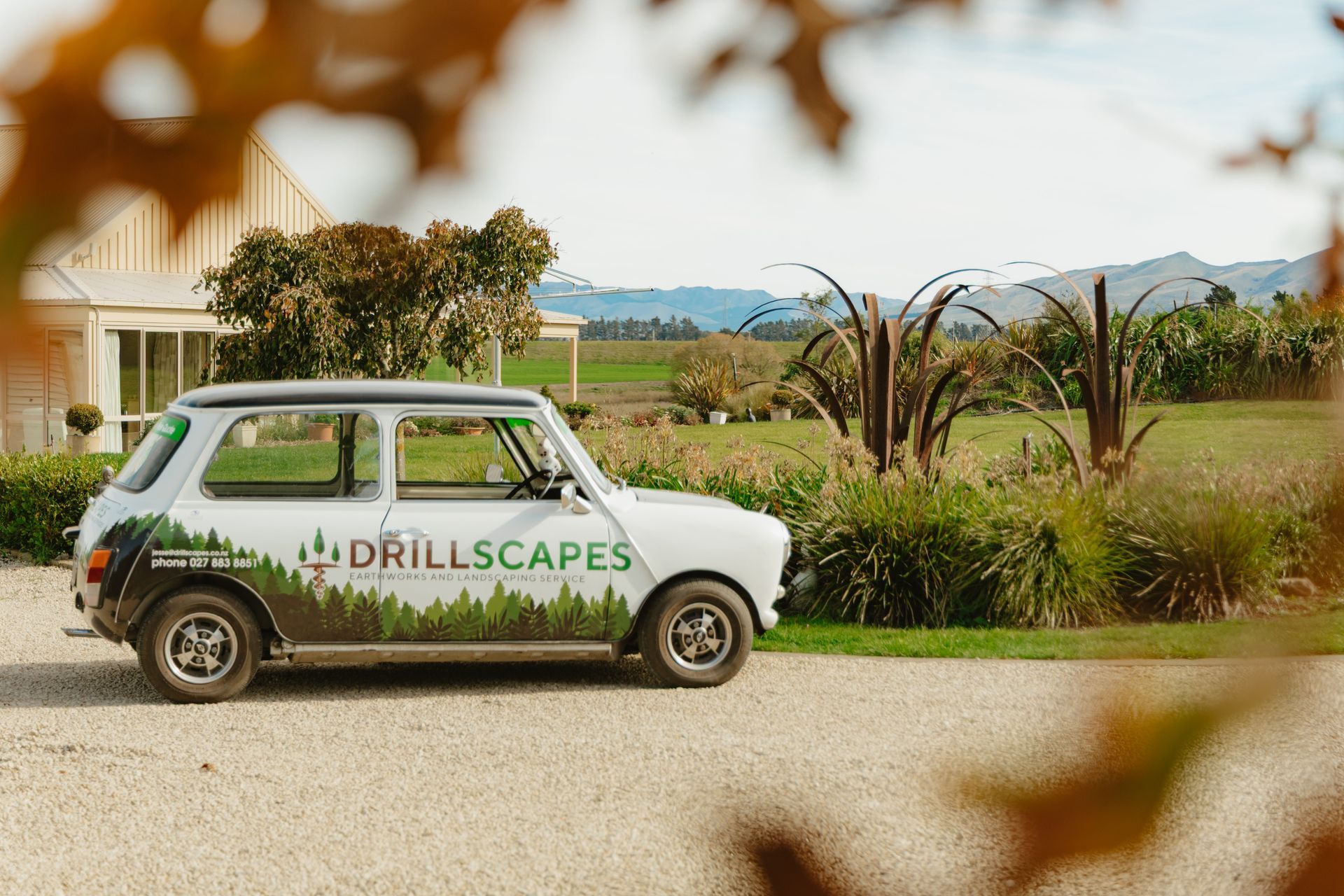 Skilled vehicle signwriters applying vinyl decals and wraps for high-impact mobile advertising.