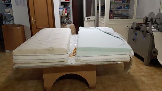 tow mattresses in a bed