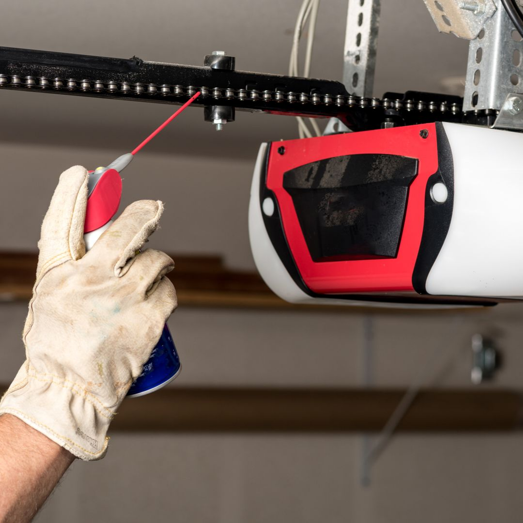 Garage door opener rail maintenance with lubricant for reliable operation.