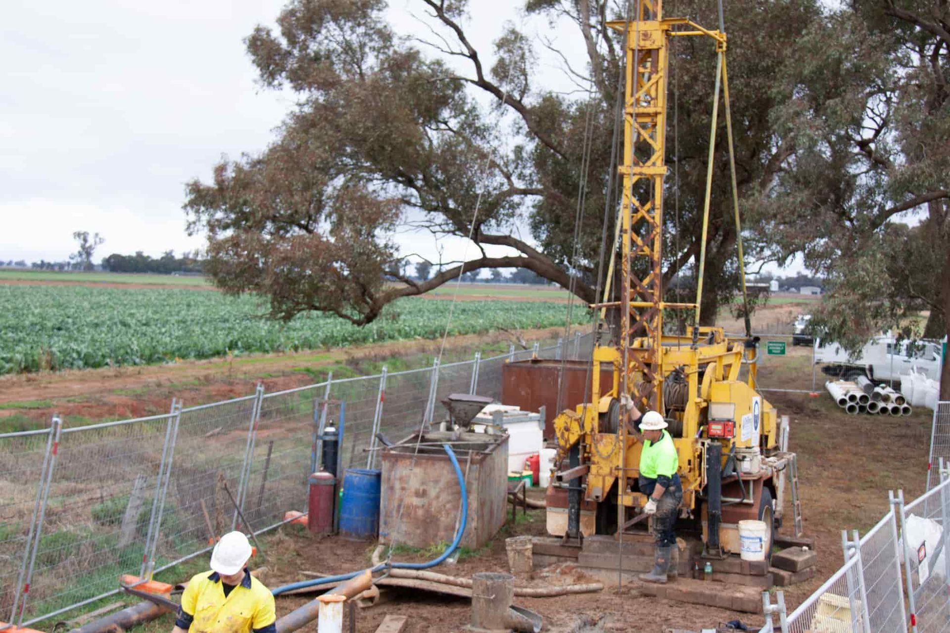 A Group Of Men Are Working On A Machine In A Field — Water Resources Drilling In Gilgandra, NSW