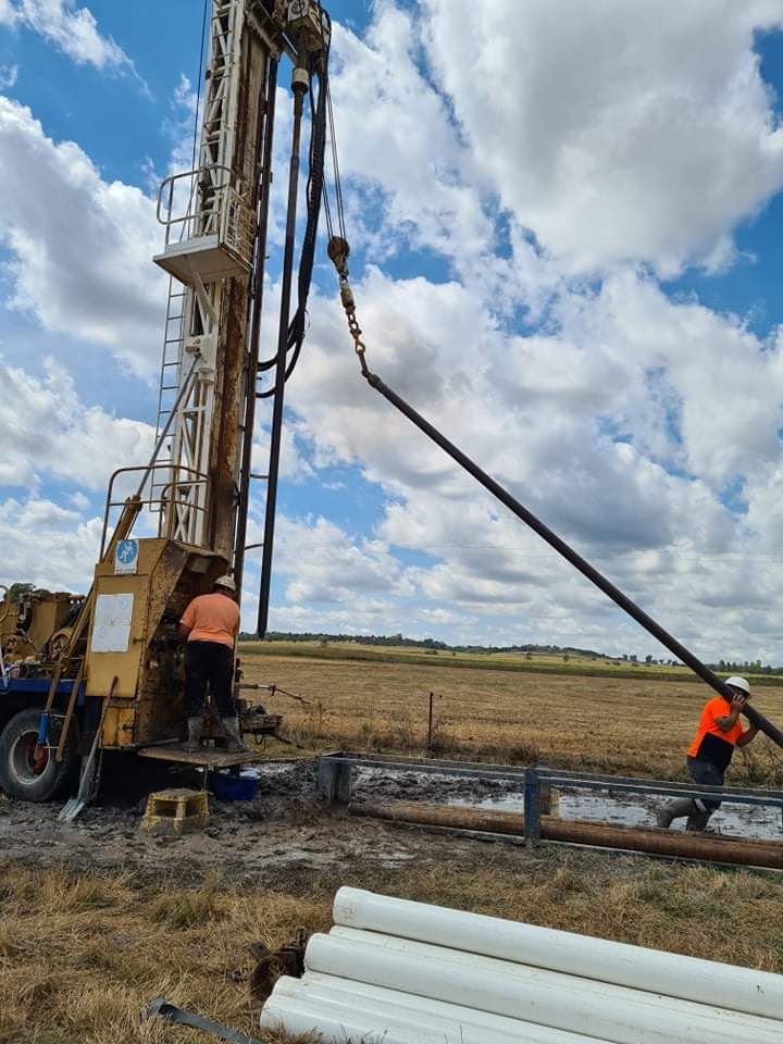 A Man Is Working On A Drilling Machine In A Field — Water Resources Drilling In Wellington, NSW