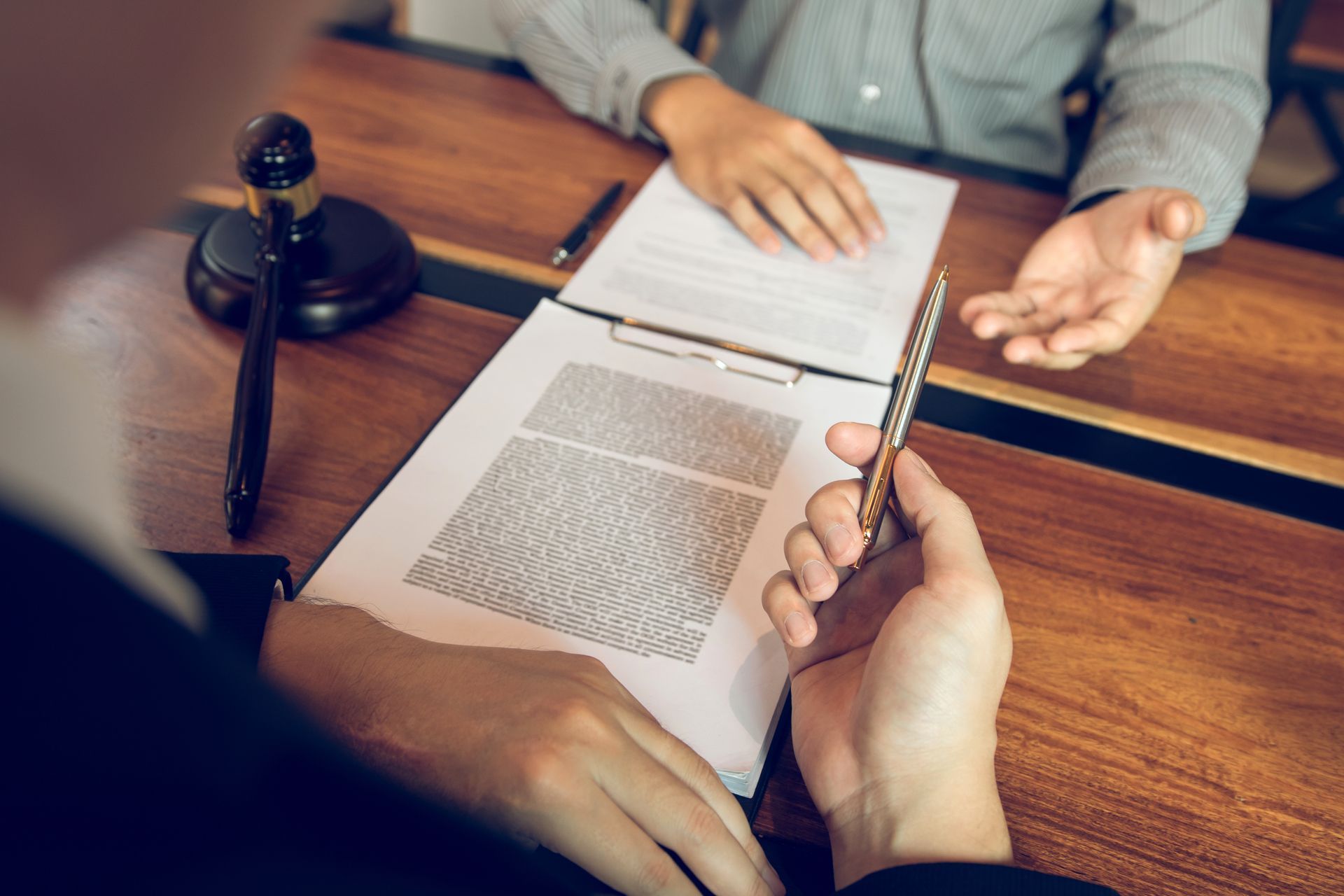 Truck driver in plaid shirt, holding a radio, driving, with sunlight streaming through the window.